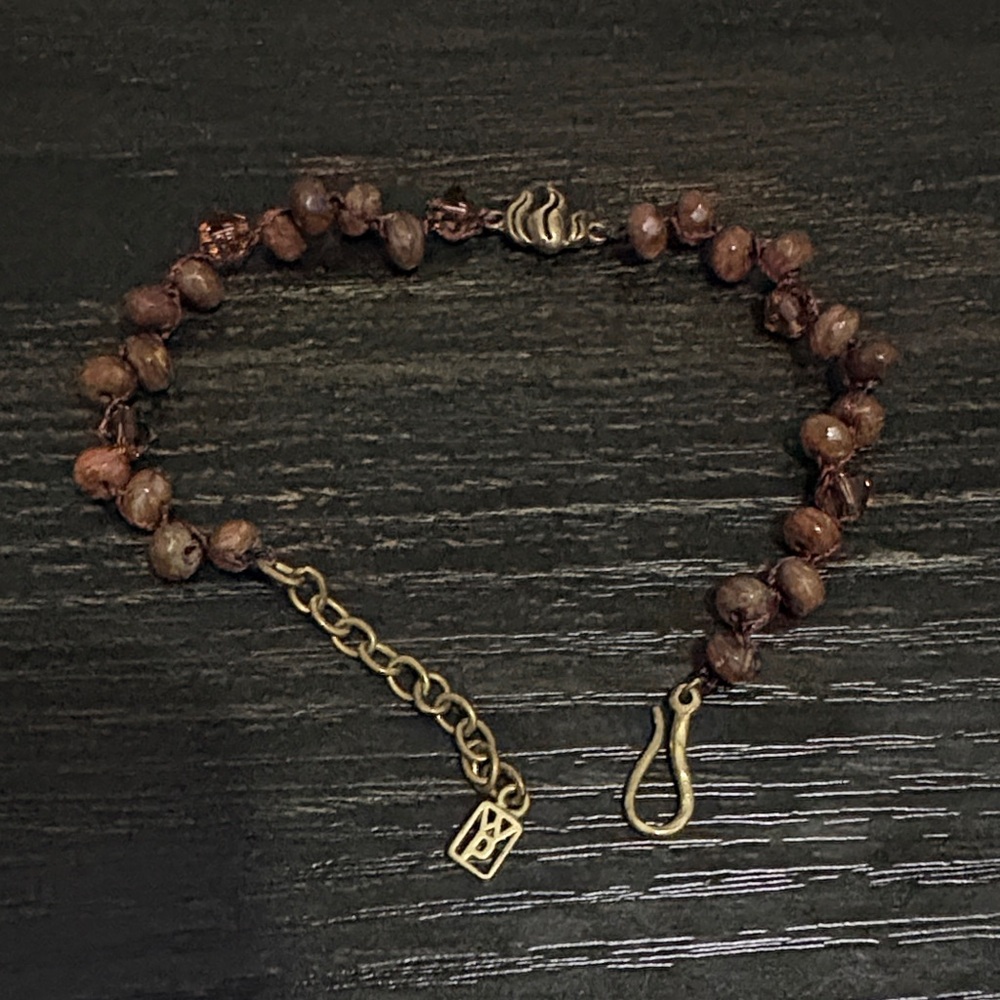 Waxing Poetic fire bracelet with reddish brown stones. Metal is brass.